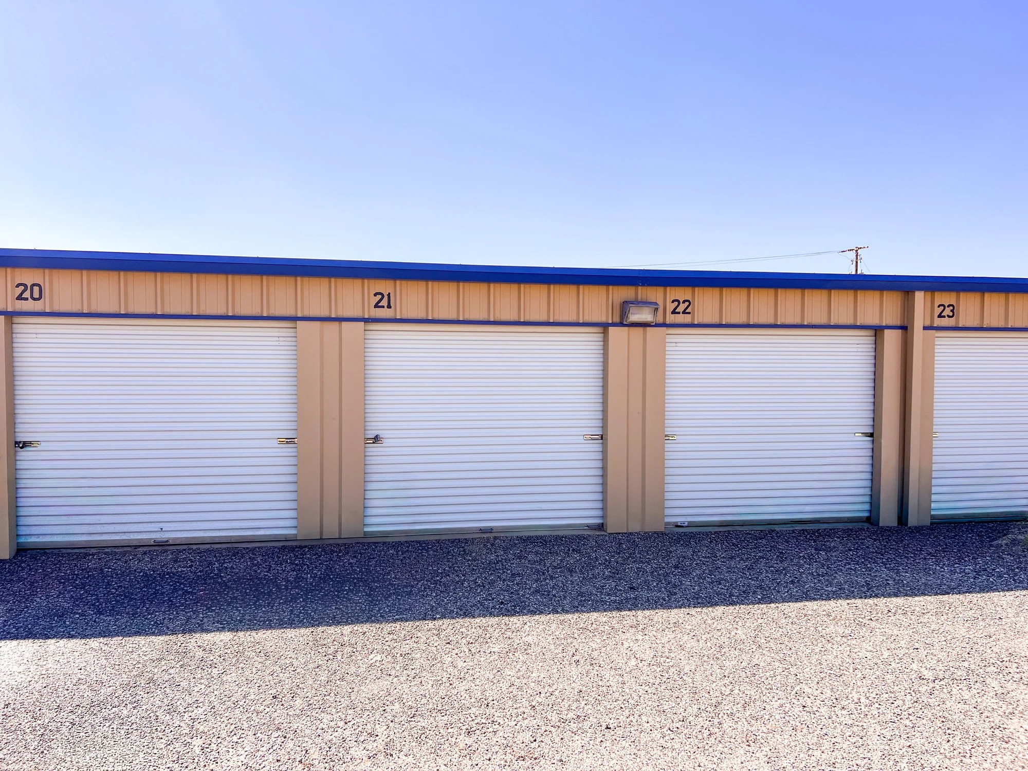 Row of drive-up storage units with roll-up doors at Mound Self Storage in Midland, TX